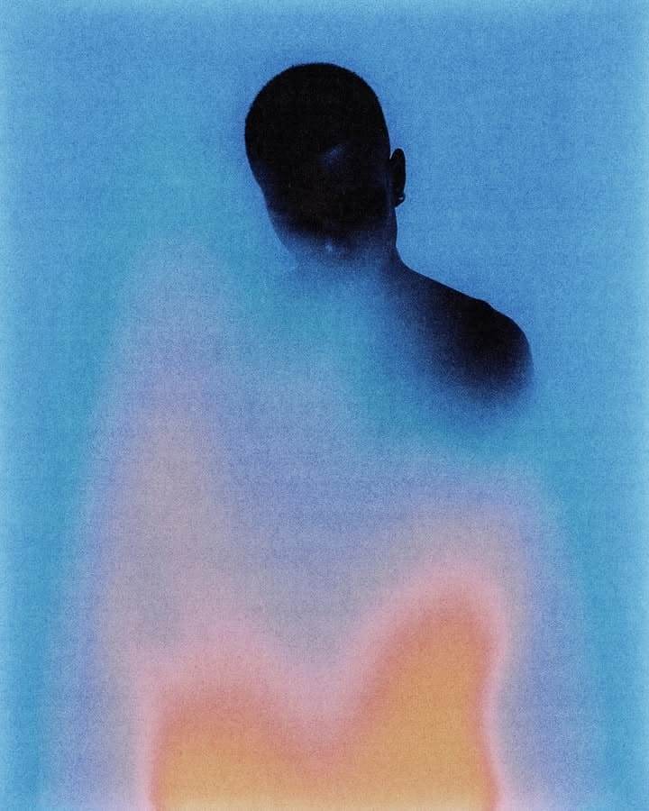 Portrait of the blog owner with face partially distorted through two clear glasses of water on a white table